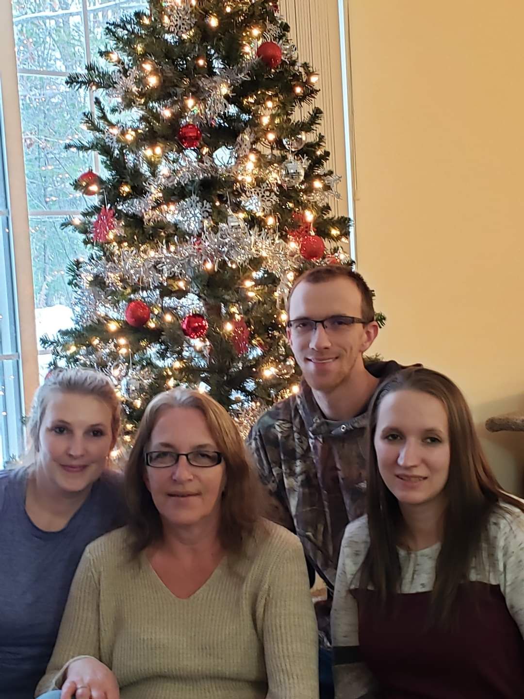 Joe with his mom and  both sisters at family Christmas